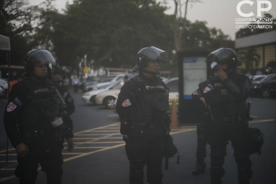 Agentes de la Unidad de Mantenimiento del Orden (UMO) custodian la entrada principal del Centro Internacional de Ferias y Convenciones (CIFCO). El error en el conteo de votos de diputados en el escrutinio preliminar enfadó a un grupo de ciudadanos que protestaron en las afueras del CIFCO, denunciando un supuesto fraude electoral.